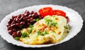 Omelet with red beans and tomato in white plate on Dark Royalty Free Stock Photo