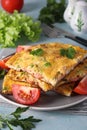 Omelet with sausages, cheese and parsley served with tomatoes on a gray plate on a light blue background Royalty Free Stock Photo