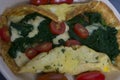 An omelet with spinach, tomatoes and cheese
