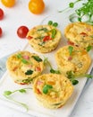 Omelet with tomatoes and bacon, baked eggs with spinach and broccoli, closeup, vertical, keto, ketogenic diet Royalty Free Stock Photo