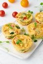 Omelet with tomatoes and bacon, baked eggs with spinach and broccoli, closeup, vertical, keto, ketogenic diet Royalty Free Stock Photo