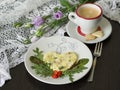 Omelet with tuna and green salad, cup of coffee with cookies in the shape of a heart against the background of delicate flowers. Royalty Free Stock Photo