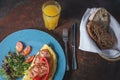 Omelet with vegetables fried bacon and orange juice