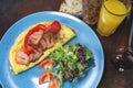 Omelet with vegetables fried bacon and orange juice Royalty Free Stock Photo