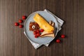 Omelette with bred toast and tomato isolated on wooden table top view
