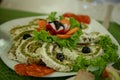 Omelette cheese roll combined with smoked sausage, sliced olives and lettuce salad on a plate with carrot Royalty Free Stock Photo