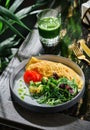 Omelette with fresh salad, arugula, avocado and tomato on plate on table with green smoothie. Healthy breakfast food, morning Royalty Free Stock Photo