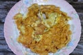 An omelette or omelet, a dish made from eggs, fried with butter or oil in a frying pan, omelet eggs with slices of onions, salted