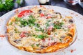 Omelette with slices ham, mushrooms, greens, cheese and tomato on dark wooden background. Royalty Free Stock Photo