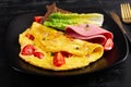 Omelette with tomatoes and cheese with bread and mortadella sausage Royalty Free Stock Photo