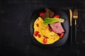 Omelette with tomatoes and cheese with bread and mortadella sausage. Royalty Free Stock Photo