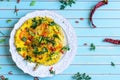 Omelette with tomatoes, chili on plate over wooden turquoise background