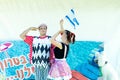 Omer (Beer-Sheva), ISRAEL -Two clowns with the Israeli flag and a white poodle - July 25, 2015 in Israel Royalty Free Stock Photo