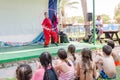 Omer, ISRAEL -The girl in a scarlet kimono with a hoop and a clown performing on the summer stage in front of the pool child