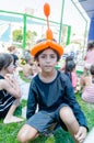 Omer, ISRAEL -Teenager sitting on the grass with other children with inflatable ball on his head in the form of a turban
