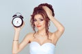 OMG I am late to my wedding. Closeup portrait of beautiful young lady girl bride showing alarm clock and looking surprised in Royalty Free Stock Photo