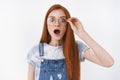 Omg no way. Impressed gasping redhead girlfriend drop jaw touch glasses astonished, pop eyes camera amazed look wondered Royalty Free Stock Photo