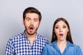 Omg! Noway! Curious shocked couple, standing in casual shirts, i