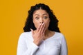 OMG. Portrait Of Shocked Black Woman Covering Mouth With Hand, Yellow Background Royalty Free Stock Photo