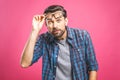 OMG! It`s incredible! Portrait of handsome young man in glasses looking at camera while standing against pink background. Close u Royalty Free Stock Photo