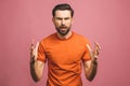 OMG! It`s incredible! Portrait of handsome young man in glasses looking at camera while standing against pink background. Close u Royalty Free Stock Photo