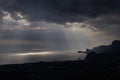 Ominous clouds and the bursting rays of light over the gulf sea