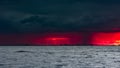 Ominous fiery dawn on the sea