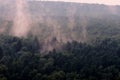 Ominous mystical fog over the forest, halloween background. Evaporation of moisture over the tops of trees after rain, timelapse Royalty Free Stock Photo