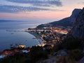 Omis, Croatia - July 23, 2021: City of Omis by night. Evening panorama of the Croatian seaside resort. Blue hour