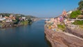 Omkareshwar cityscape, India, sacred hindu temple. Holy Narmada River, boats floating. Travel destination for tourists and pilgrim