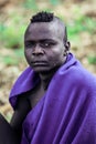 Portrait of Serious and Brave African Man in Traditional dress and Wooden Stick in the local Mursi tribe village