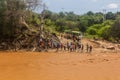 OMO VALLEY, ETHIOPIA - FEBRUARY 4, 2020: People at the ford of Kizo river, Ethiop