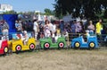 Omsk, Russia - August 05, 2012: Children and parents in amusement park Royalty Free Stock Photo