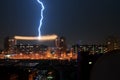OMSK, RUSSIA - August 7, 2012: Thunderstorm in the city, lightning struck in the power line between the houses