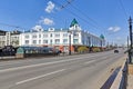 Omsk, Russia. Modern street in the background of a building built in the 19th century