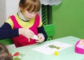 Omsk, Russia - September 24, 2011: schoolgirl glues applique at school desk Royalty Free Stock Photo
