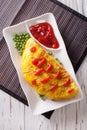 Omurice omelet stuffed with rice closeup. vertical top view