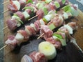 Rows of raw prepared pork skewers