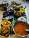 Onam special meals made with vegetables in separate vessels in an array.