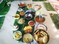 Onam special meals made with vegetables in separate vessels in an array.