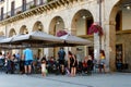 People of different age having drinks outside on the terrace of local bar