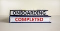 Onboarding completed symbol. Books with words `Onboarding completed`. Beautiful white background. Business, onboarding completed