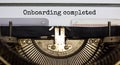 Onboarding completed symbol. Words Onboarding completed typed on retro typewriter. Business and onboarding completed concept. Royalty Free Stock Photo