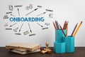 ONBOARDING. Office supplies and books on a wooden table Royalty Free Stock Photo