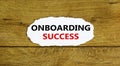 Onboarding success symbol. Words `Onboarding success` on white paper. Beautiful wooden background. Business, onboarding success