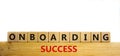 Onboarding success symbol. Words `Onboarding success` on wooden cubes. Business and onboarding success concept. Beautiful wooden