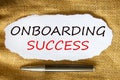 Onboarding success symbol. Words `Onboarding success` on white paper. Black metallic pen. Beautiful canvas background. Business,