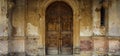 The once grand entrance of a majestic castle now shows signs of wear and tear. The intricate details of the wooden door Royalty Free Stock Photo