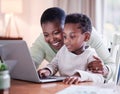 Once a mother, always a mother. a mother helping her son with his homework at home. Royalty Free Stock Photo