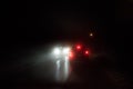 Oncoming traffic by night and fog